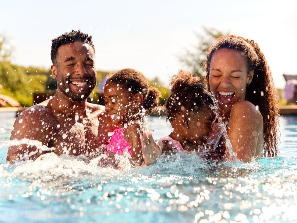 family splashing in pool